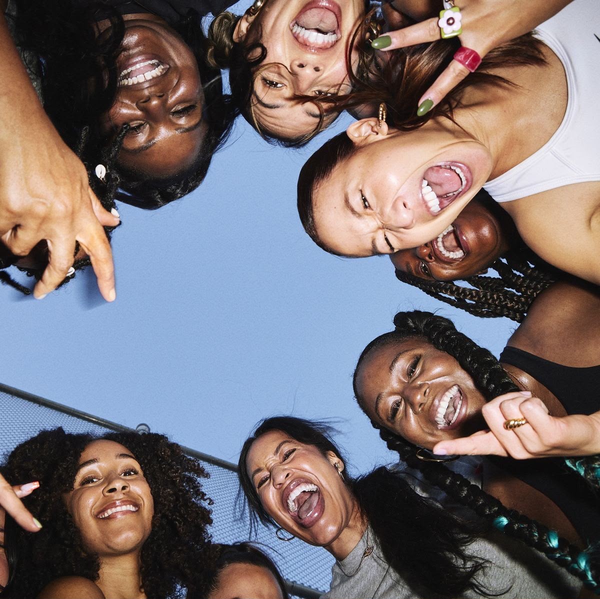 A circle of women joyfully together, representing the SHEA Works cohort community